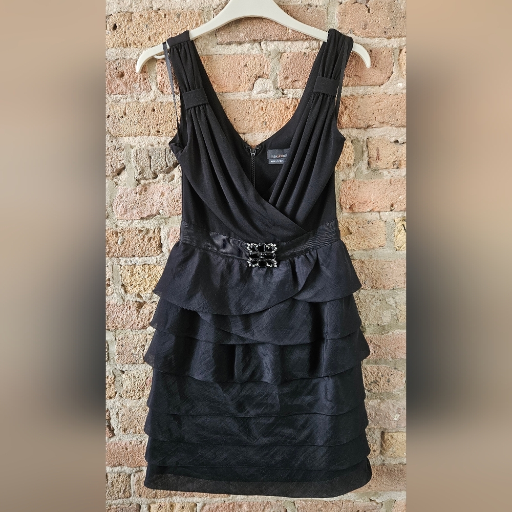 Elegant Black Sleeveless Dress with Brooch